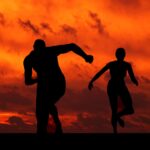 man and woman running silhouette